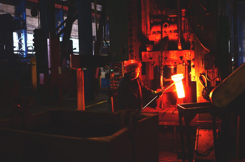 Blacksmith Processes The Red Hot Iron Under A Huge Press. Metal